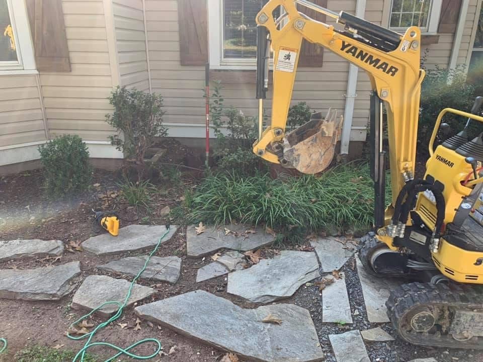 Mini excavator working on residential septic repair